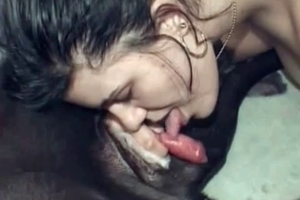 Sexy chick is sucking and licking a big dog dick